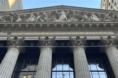 Stock market today: Dow closes at a record even as losses for .